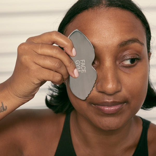 Model holding gua sha