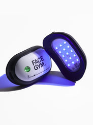 Acne Light Shot LED Device for skin pack shot with two devices, one laid flat and the other propped up to show the LED