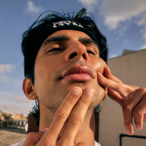a man with his hands on his face