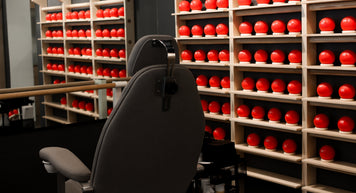 a chair in front of a shelf with red balls